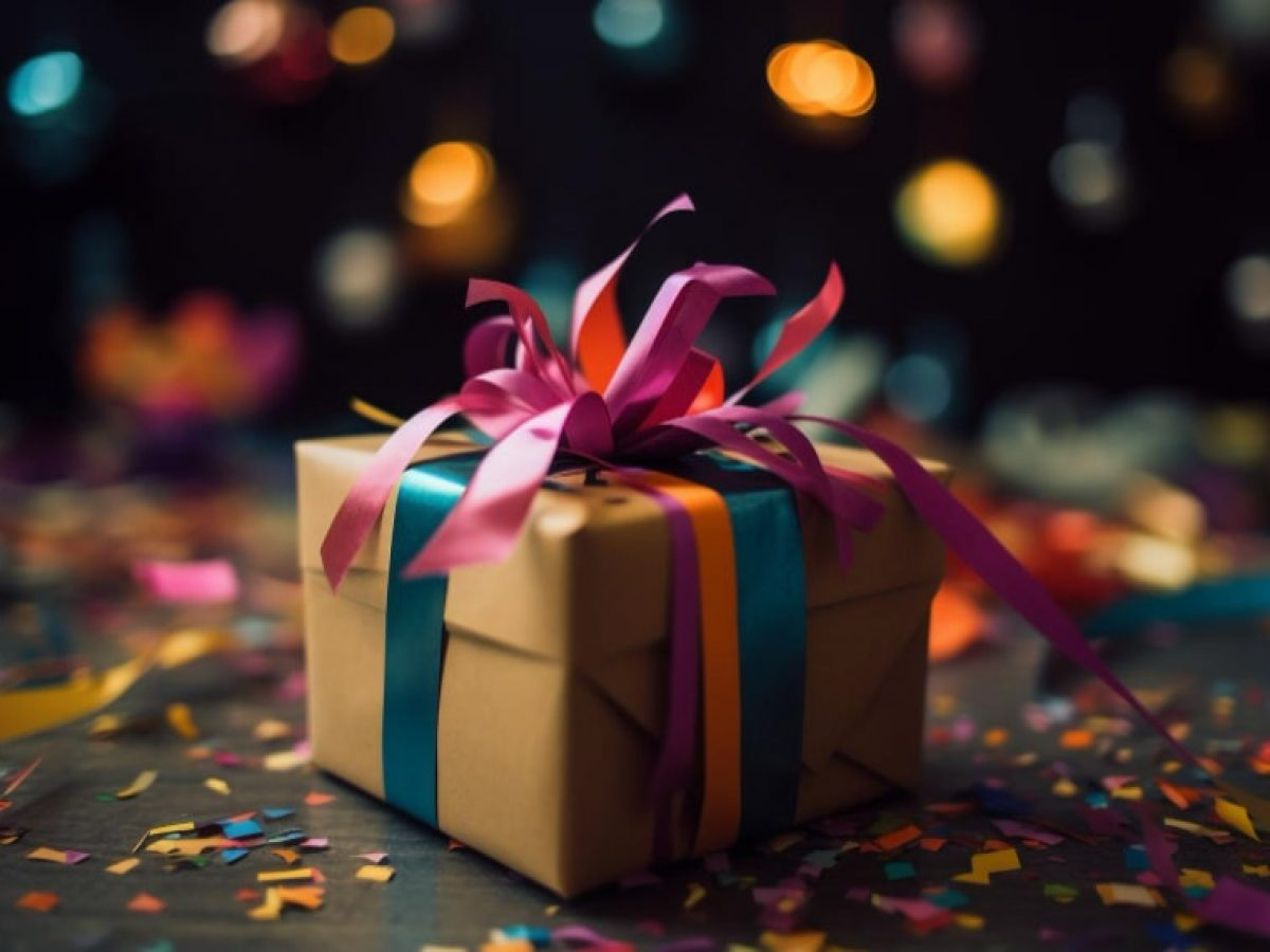 Gift box with colourful ribbons and confetti